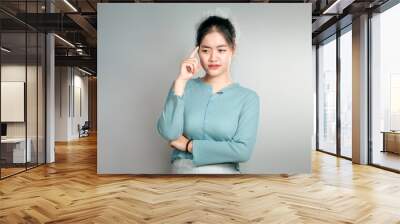 young asian woman have thinking gesture. Wall mural