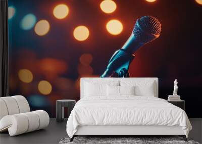 A microphone stands ready for a performance during a vibrant evening at a live music venue with glowing lights and a lively atmosphere Wall mural