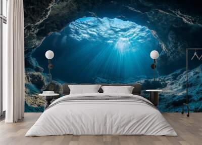 Sunlight filtering through underwater cave in a tranquil ocean setting Wall mural