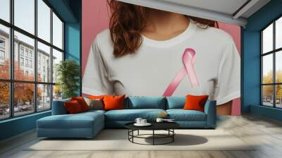 Empowered Woman in White T-Shirt with Pink Ribbon Symbolizing Support and Awareness Wall mural