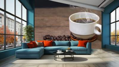 A cup of hot espresso coffee mugs and roasted coffee beans placed on wooden floor background,coffee morning,selective focus Wall mural