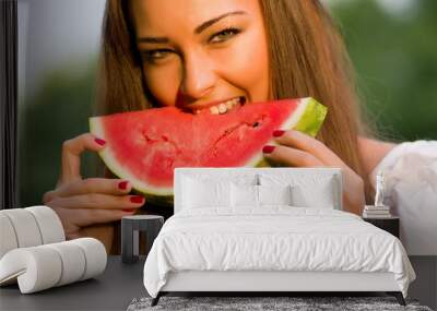 Pretty woman eating watermelon outdoor Wall mural