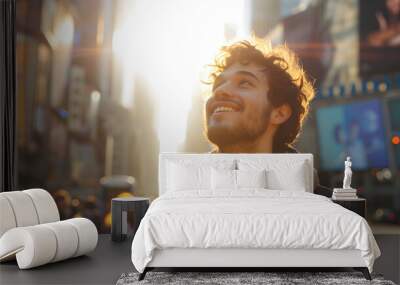 happy young caucasian man looking up at the sky alone in a busy city, sun shining Wall mural