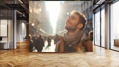 happy young caucasian man looking up at the sky alone in a busy city, sun shining Wall mural