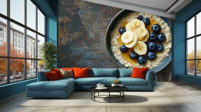 a bowl of creamy oatmeal topped with sliced bananas Wall mural