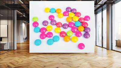 Various colored chocolate candies on a white background Wall mural