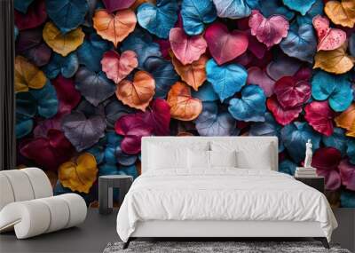 Abstract close-up of colorful leaves creating a vibrant and textured pattern with various hues Wall mural