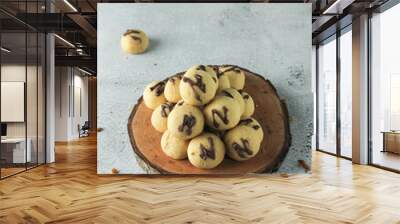 cake ball with chocolate on topping. indonesian cake or cookies. served on wooden place map in grey and texture background. inscription 