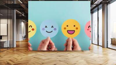 Hands holding happy smile face paper cut. Wall mural