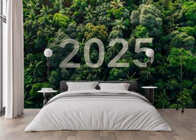 2025 New Year concept. Stone numbers displaying 2025 surrounded by dense, lush greenery and plants, symbolizing environmental sustainability and future focus. SDGs, ESG, NetZero, and co2 concept Wall mural