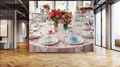 Table set up for bridal shower on bright spring day with flowers in the middle and vintage tea cups on each plate Wall mural