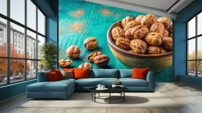 Walnuts in a bowl on vibrant turquoise surface, healthy snack concept for kitchen decor or food blog background Wall mural