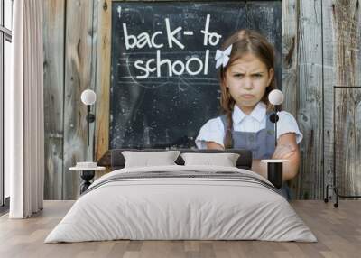 schoolgirl looking at camera with back to school text. sad student because school is open. education concept background, banner, poster. Wall mural