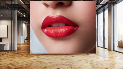 A close-up of a woman's attractive lips with red lipstick. Wall mural