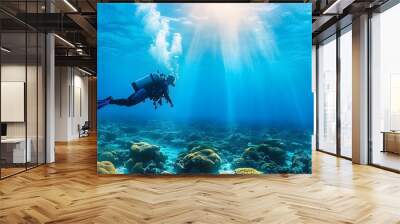 A serene underwater scene featuring a diver exploring vibrant coral reefs under sun beams. Wall mural