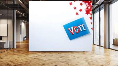 A vibrant image featuring a blue card that says 'VOTE' surrounded by red stars, symbolizing civic engagement and democracy. Wall mural