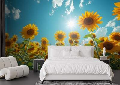 Sunflower field in full bloom, with a bright blue sky and the sun shining overhead, highlighting the beauty of nature in summer. List of Art Media Photograph inspired by Spring magazine Wall mural