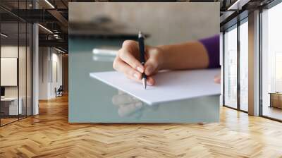 Businesswoman writing with pen Wall mural