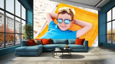 Little boy relax on deckchair Wall mural