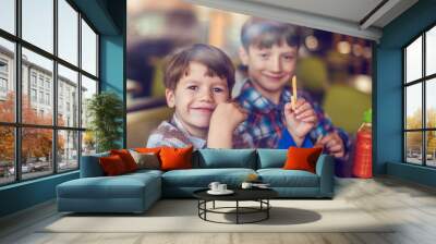 Little boys eating french fries in fast food restaurant Wall mural