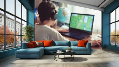 little dependent gamer kid playing on laptop at home Wall mural