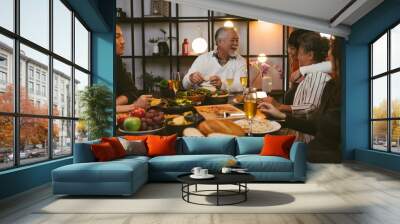 Asian family having dinner at dining table at home Wall mural