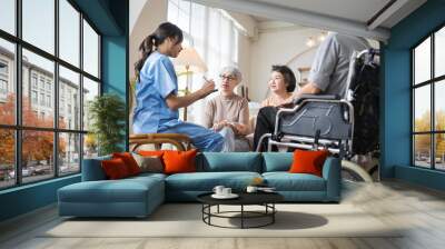 Group of Asian senior people sit in a circle in a nursing home and listen to nurse during a group elderly therapy session. Wall mural