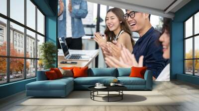 Happy Asian business clapping hands after business meeting successful in modern office Wall mural