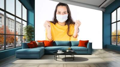 Young happy Asian woman wearing hygienic mask to prevent infection corona virus Air pollution pm2.5 she wearing a yellow sweater shoot in shot isolated on white background Wall mural