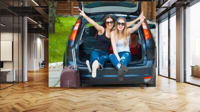 Two girls posing in car Wall mural