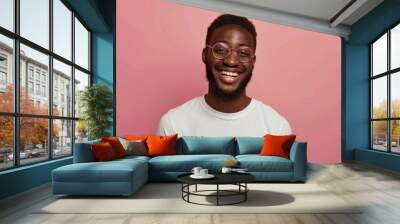 Happy male model in glasses receives work bonus. Wall mural