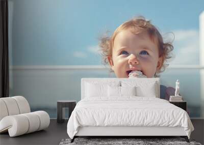 little girl eating a cone of ice cream on a sunny summer day Wall mural