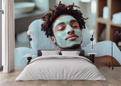 young afro american man with a facial mask at a spa treatment Wall mural