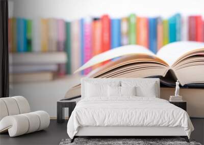 Close-up open book with library bookshelf toned background Wall mural