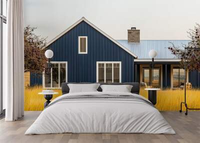 Sleek modern farmhouse home with vertical midnight blue paneling, white trim, on golden yellow grass and encased by plum trees, contrasting rural charm with elegance Wall mural