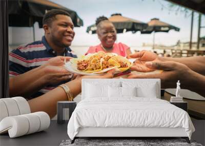 A group of African American friends shared tacos at a beach restaurant. Garifuna group from Guatemala. Wall mural