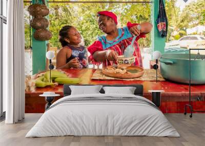 African American mother and daughter or grandmother and granddaughter enjoy the moment of being together in the kitchen. Happy family in the kitchen. Wall mural