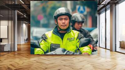  an Indonesian men working as online motorcycle taxi driver in green color safety driving clothing Wall mural