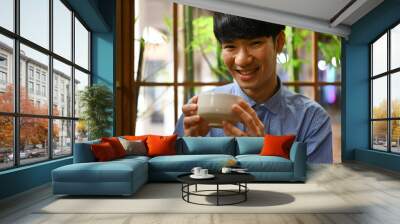 Close up with A Happy Young Asian man enjoying Japanese traditional matcha tea, The concept of drinking green tea for health Wall mural