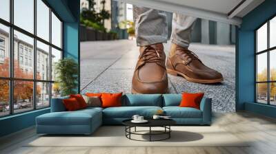 close up shot featuring stylish pair brown sneakers adorned by man s legs in light gray trousers trendy casual fashion concept modern style and youthful vibe person Wall mural