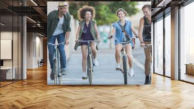 Friends riding bicycles on urban sidewalk Wall mural