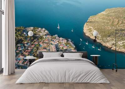 Aerial bird's eye view drone of boat docked in mediterranean tropical beach with turquoise - sapphire waters Wall mural