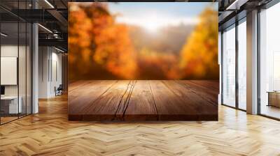 product display on rustic wooden plank in idyllic autumn nature scene backdrop with blurred sunlights and colorful bokeh motion background Wall mural