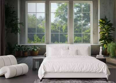 Two white pillows sit on a rug in front of a large window with a view of lush green trees and a bright, sunny day. Wall mural