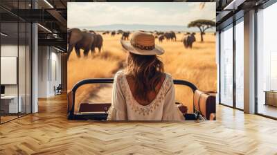 woman standing in a safari vehicle tourist elephant in the savanna travel summer Wall mural