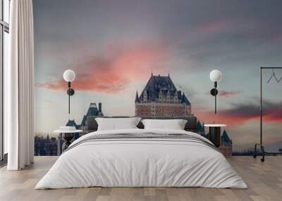 Vertical breathtaking view of old castle on pink sunset sky background in Quebec City Wall mural