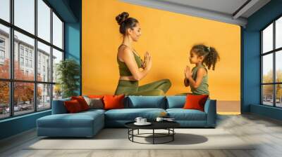 Mom and daughter practicing yoga together, close-up. Wall mural