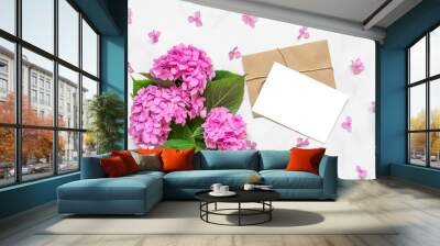 Blank greeting card in petals frame with pink hydrangea flowers bouquet on white background. mock up. flat lay Wall mural