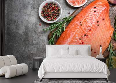 Fresh raw salmon fish fillet with cooking ingredients, herbs and lemon on gray concrete background. Healthy diet food Wall mural