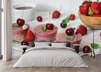 healthy breakfast. raw strawberry and cherry cakes with fresh berries, mint, nuts and coffee cup Wall mural